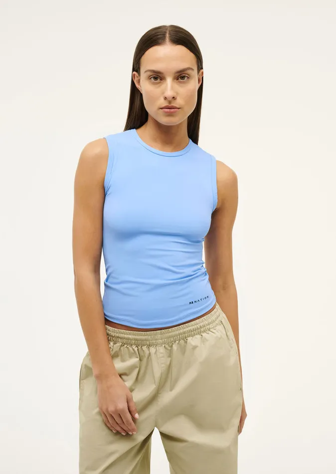 PE Nation FOUNDATION MUSCLE TANK IN CORNFLOWER BLUE Women Bodyluxe