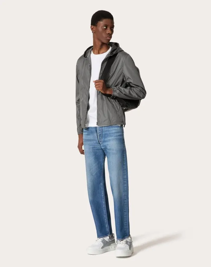 Valentino Outerwear Man Nylon Hooded Windbreaker With Metallic V Detail For Man In Grey Grey Valentino Outerwear Man Nylon Hooded Windbreaker With Metallic V Detail For Man In Grey Grey