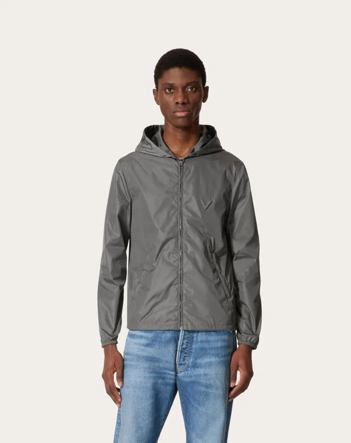Valentino Outerwear Man Nylon Hooded Windbreaker With Metallic V Detail For Man In Grey Grey Valentino Outerwear Man Nylon Hooded Windbreaker With Metallic V Detail For Man In Grey Grey