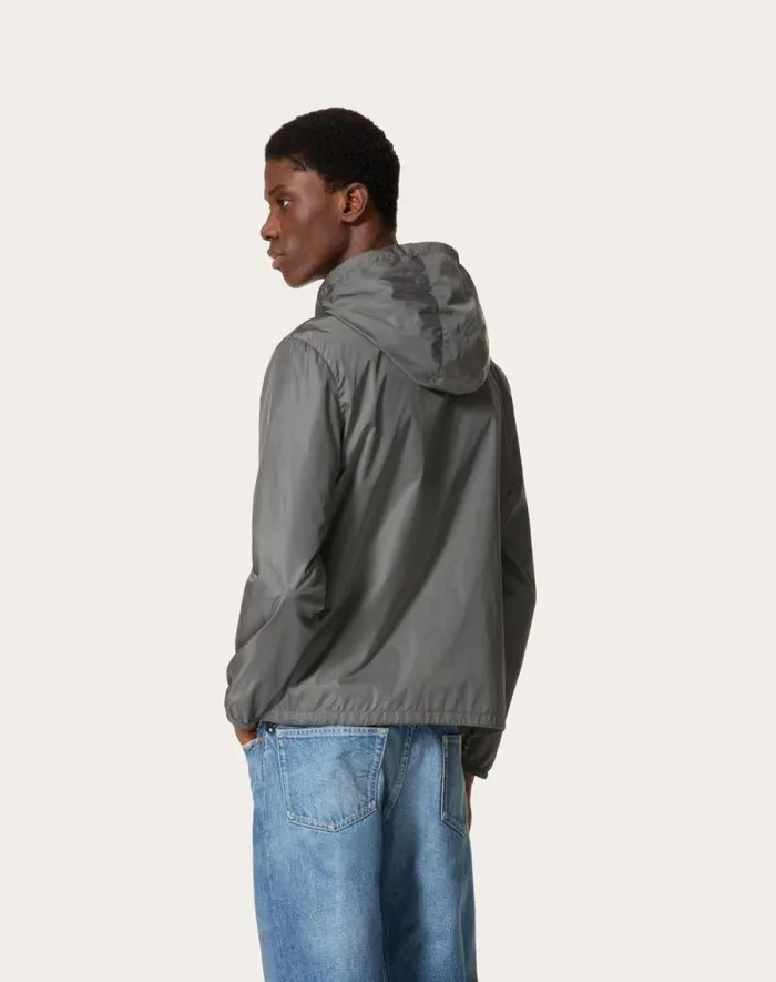 Valentino Outerwear Man Nylon Hooded Windbreaker With Metallic V Detail For Man In Grey Grey Valentino Outerwear Man Nylon Hooded Windbreaker With Metallic V Detail For Man In Grey Grey