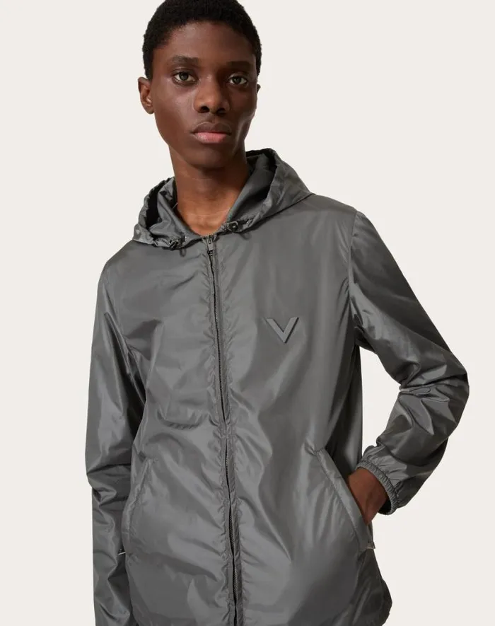 Valentino Outerwear Man Nylon Hooded Windbreaker With Metallic V Detail For Man In Grey Grey Valentino Outerwear Man Nylon Hooded Windbreaker With Metallic V Detail For Man In Grey Grey
