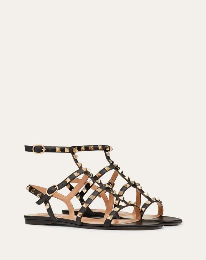 Valentino Sandals Woman Rockstud Flat Calfskin Sandal With Straps For Woman In Poudre Poudre