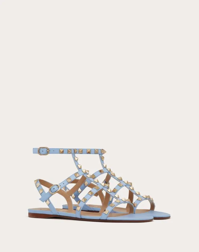 Valentino Sandals Woman Rockstud Flat Calfskin Sandal With Straps For Woman In Poudre Poudre