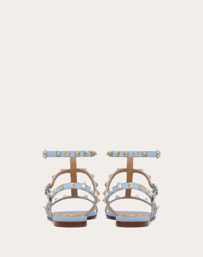 Valentino Sandals Woman Rockstud Flat Calfskin Sandal With Straps For Woman In Poudre Poudre