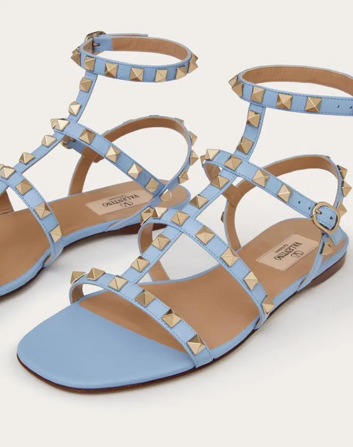 Valentino Sandals Woman Rockstud Flat Calfskin Sandal With Straps For Woman In Poudre Poudre