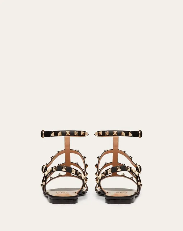 Valentino Sandals Woman Rockstud Flat Calfskin Sandal With Straps For Woman In Poudre Poudre