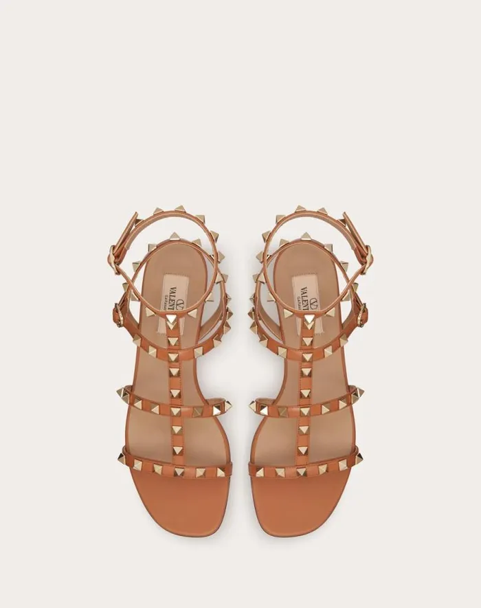 Valentino Sandals Woman Rockstud Flat Calfskin Sandal With Straps For Woman In Poudre Poudre