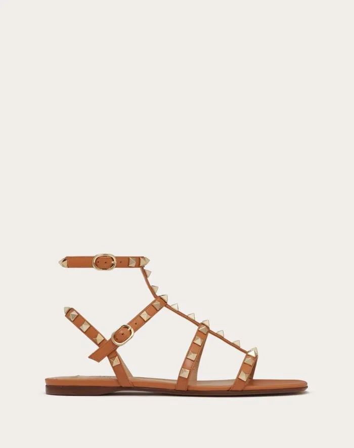 Valentino Sandals Woman Rockstud Flat Calfskin Sandal With Straps For Woman In Poudre Poudre
