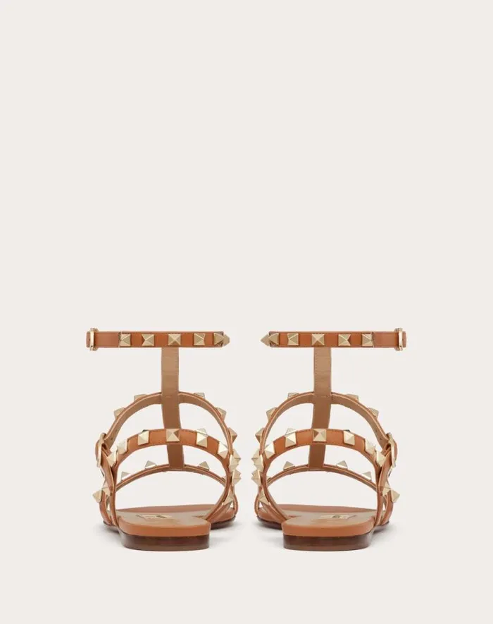 Valentino Sandals Woman Rockstud Flat Calfskin Sandal With Straps For Woman In Poudre Poudre