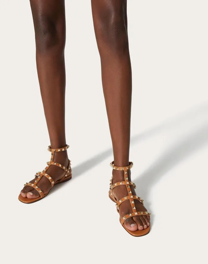 Valentino Sandals Woman Rockstud Flat Calfskin Sandal With Straps For Woman In Poudre Poudre