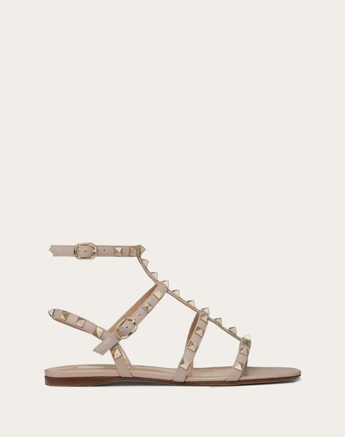 Valentino Sandals Woman Rockstud Flat Calfskin Sandal With Straps For Woman In Poudre Poudre