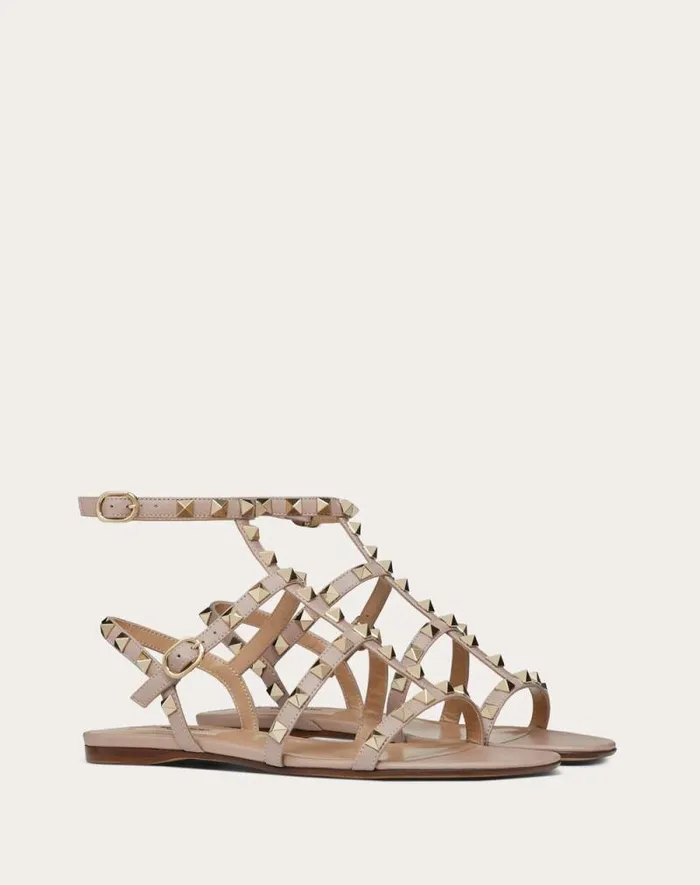 Valentino Sandals Woman Rockstud Flat Calfskin Sandal With Straps For Woman In Poudre Poudre