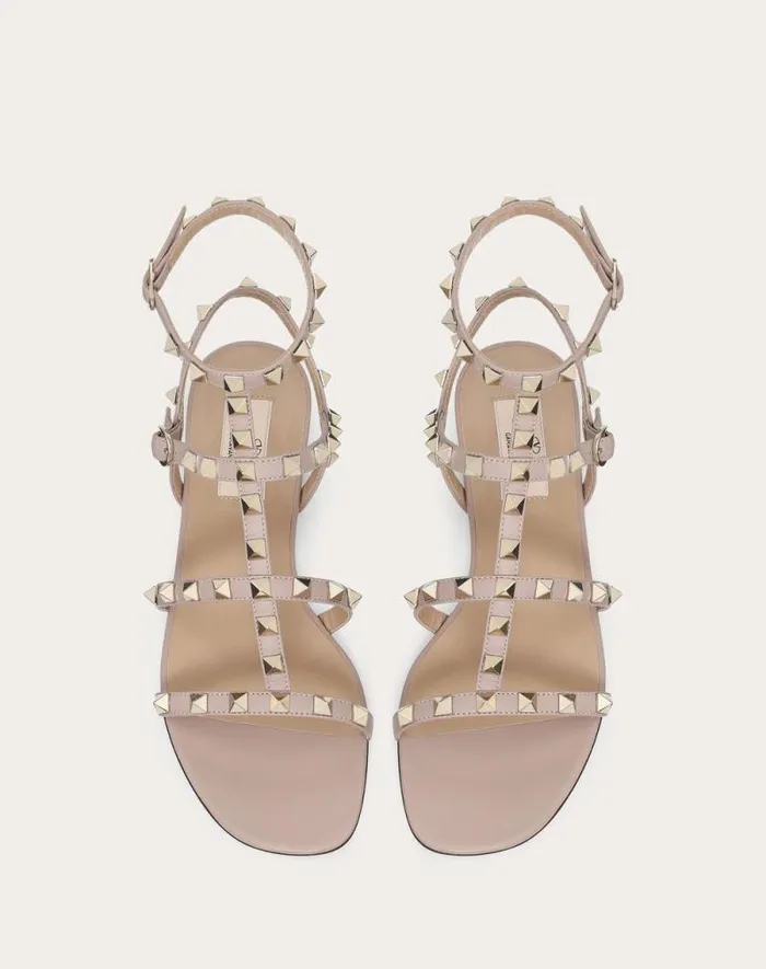 Valentino Sandals Woman Rockstud Flat Calfskin Sandal With Straps For Woman In Poudre Poudre